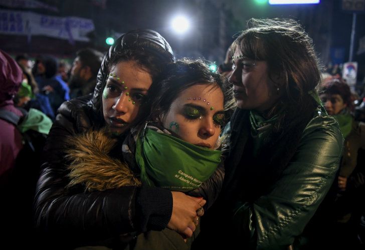 Pro-choice campaigners embrace after the result of the Senate vote became known.