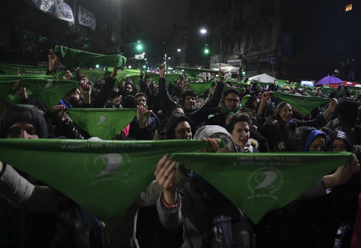 Pro-abortion reform campaigners hold their green scarves aloft, after the Senate voted to reject a bill to legalise elective abortion.