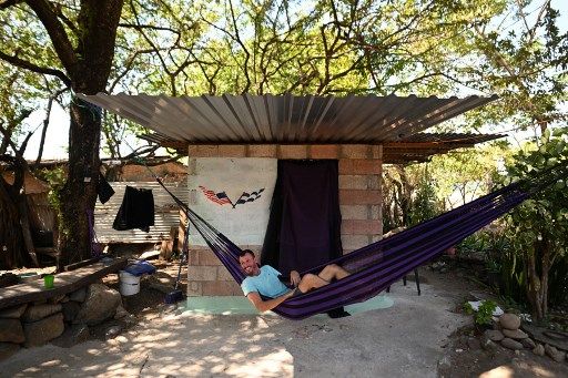 El bitcoiner estadounidense Corbin Keegan descansa en una hamaca afuera de la habitación que construyó en el patio de una casa de pescadores en Playa Blanca