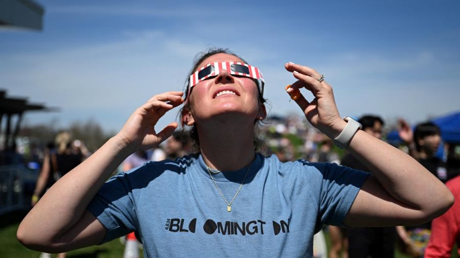 La gente mira hacia el cielo antes de un eclipse solar total en América del Norte