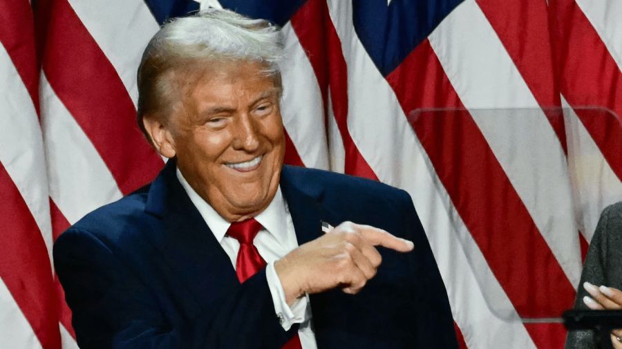 Former US President and Republican presidential candidate Donald Trump points to his wife former US First Lady Melania Trump during an election night event