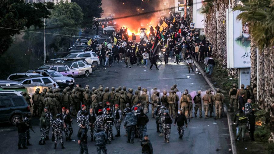 Fotogaleria El fuego de neumáticos quemados arde mientras partidarios del movimiento islamista chiita libanés Hezbolá se presentan ante soldados del ejército libanés durante una manifestación