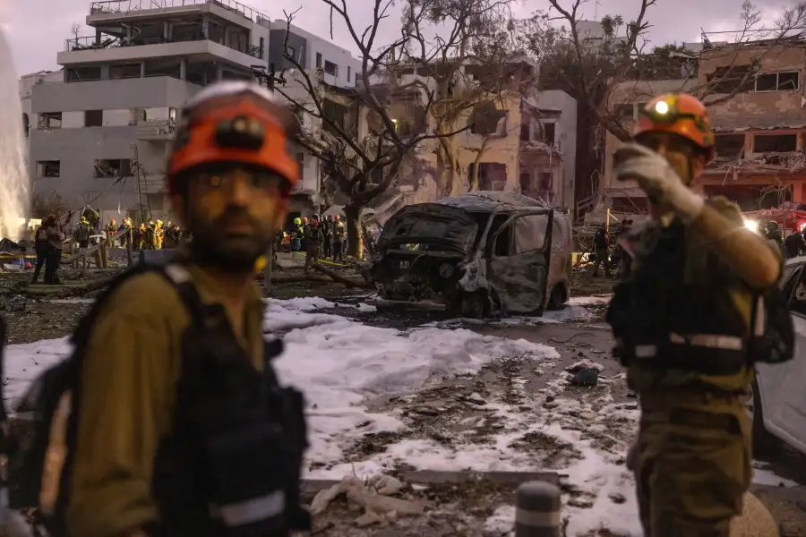 Rescue workers at the site of an Iranian strike in Tel Aviv, on June 16