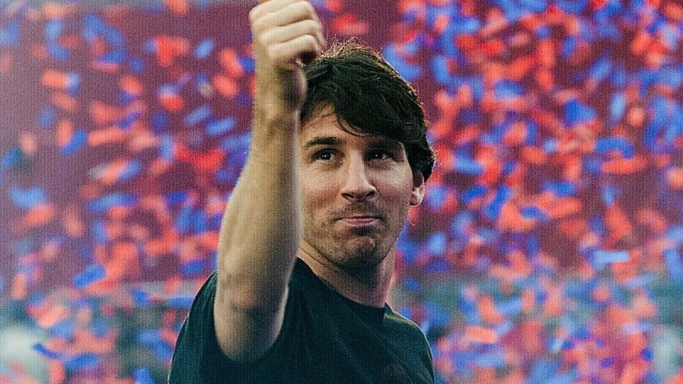 Messi devuelve un saludo en medio de una lluvia de papelitos.