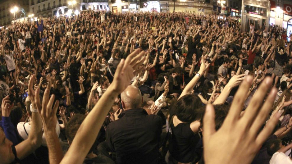 Asistentes a la concentración convocada por el movimiento social 15M en la Puerta del Sol de Madrid, durante el "grito mudo" realizado a las 0 horas.