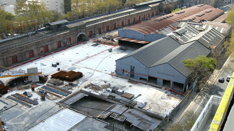 En obra. Excavadoras, grúas y camiones trabajan en el lugar.