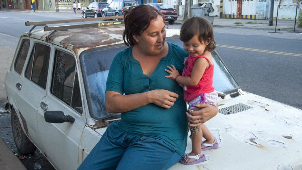 Sin casa. Diana y Carlina, su hija de casi dos años con leucemia, sentadas sobre su "hogar".