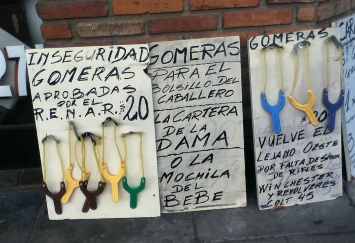 Los carteles, que mezclan la cruda realidad con un toque de sarcasmo, y exhiben colgadas las gomeras de diferentes colores “a solo $20”.