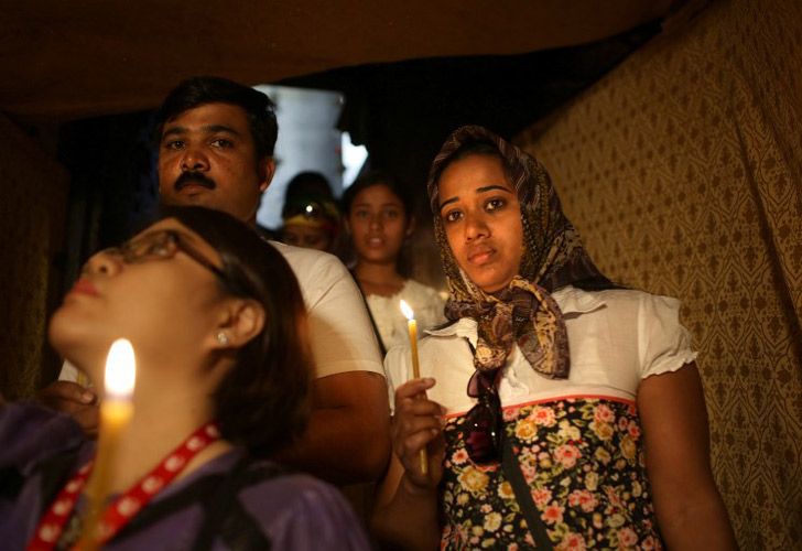 Peregrinos católicos esperan con velas para entrar a la Gruta en la Iglesia de Natividad, creída ser el lugar de nacimiento de Jesucristo, en Cisjordania de Belén.