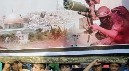 Inocencia interrumpida. Un grupo de niños palestinos se esconden debajo de un cartel de un miliciano islamista en Gaza.