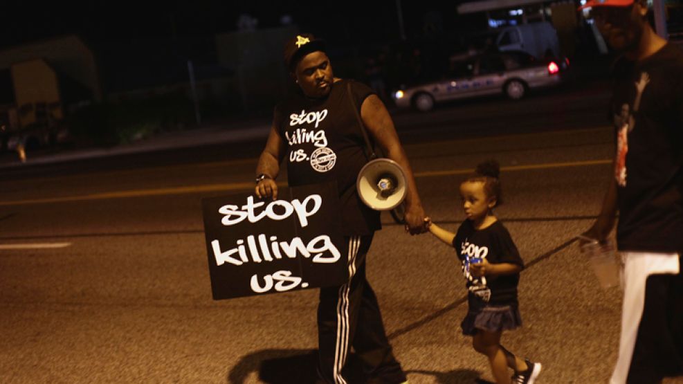 Paren de matarnos. Un hombre y su hija protestan en Missouri.