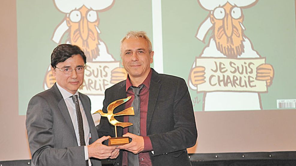 Premiado. Fontevecchia junto a Antonio Fischetti, sobreviviente del equipo de Charlie Hebdo.
