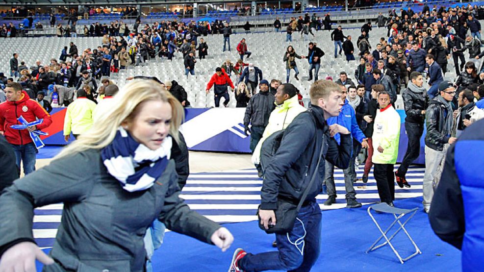 Tensión. La policía acordonó rápidamente el Estadio de Francia, luego de los ataques de dos kamikazes. Después de evacuar a Hollande, hubo escenas de pánico.