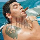 ARGENTINE SOCCER STARDIEGO MARADONA SMOKES A COHIBA AS HE TAKES RIDES A SAILBOAT