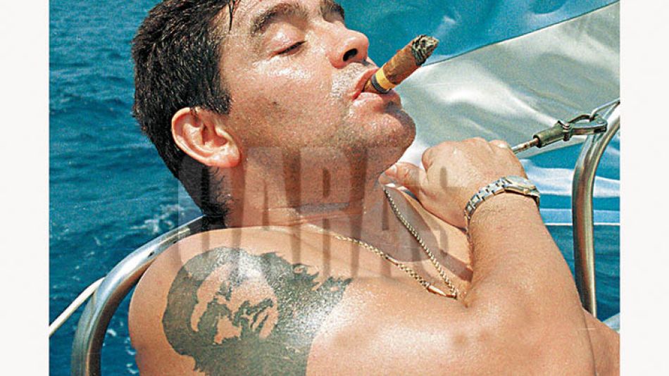 ARGENTINE SOCCER STARDIEGO MARADONA SMOKES A COHIBA AS HE TAKES RIDES A SAILBOAT