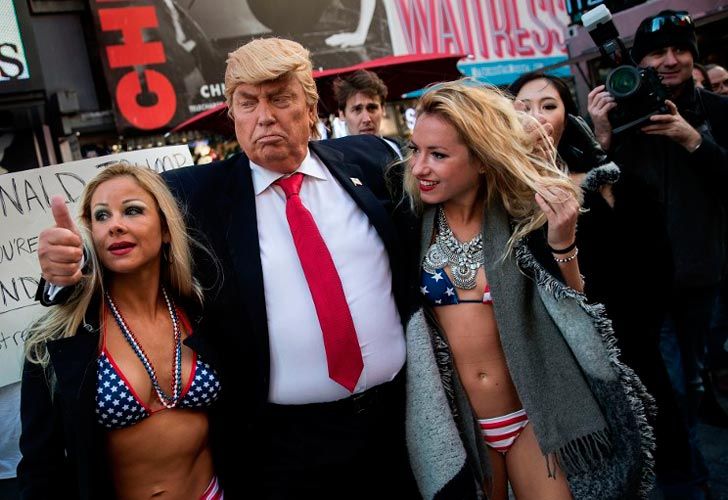 Un falso Trump rodeado de chicas en bikini.