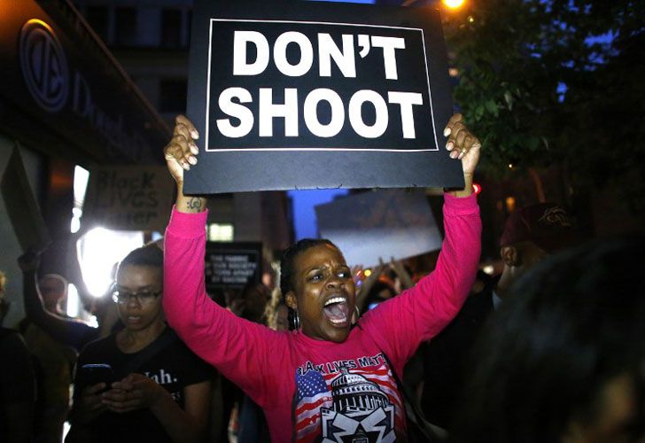 Una mujer sostiene una bandera durante una protesta en apoyo del movimiento negro de la materia de las vidas en Nueva York el 09 de julio de 2016. El pistolero detrás de un ataque del francotirador-estilo en Dallas era un veterano del ejército y solitario conducido para vengarse de los oficiales blancos después de la Las recientes muertes de dos hombres negros a manos de la policía, dijeron las autoridades. Micah Johnson, de 25 años, no tenía antecedentes penales, dijo la policía de Dallas en un comunicado.