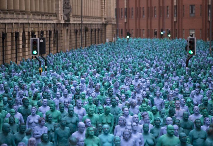 Los voluntarios desnudos, pintados en azul para reflejar los colores encontrados en pinturas de la marina en la galería de arte de Ferens del casco, participan en la instalación del "mar del casco" de Spencer Tunick del artista en Kingston upon Hull el 9 de julio de 2016.