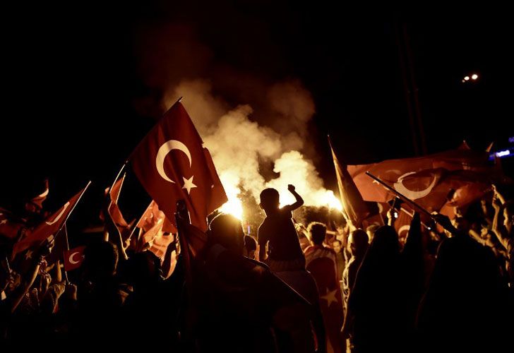 Los partidarios de Pro-Erdogan ondean las banderas nacionales turcas durante una reunión en la plaza de Taksim en Estambul el 18 de julio de 2016 después del intento fallido militar del golpe del 15 de julio.