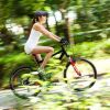 11784344-girl-cycling-in-the-park-motion-blured-image