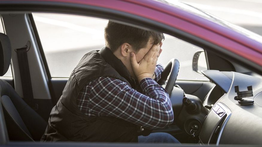 portrait-of-shocked-male-driver-closing-face-with-hands