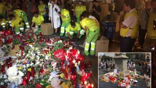Ante la atenta mirada de Pisarello, los empleados municipales retiran las flores del espacio memorial.
