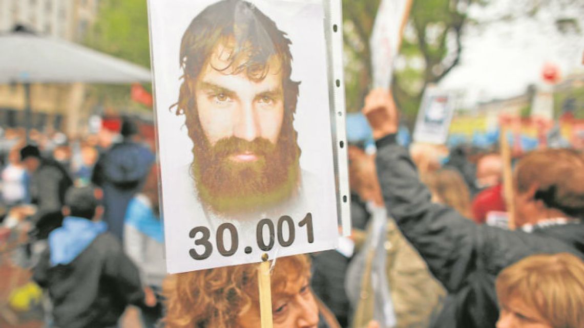 A woman holds a photo of Santiago Maldonado during a demonstration at Plaza de Mayo last Sunday. The number refers to the number of persons disappeared during the 1976-1983 dictatorship.