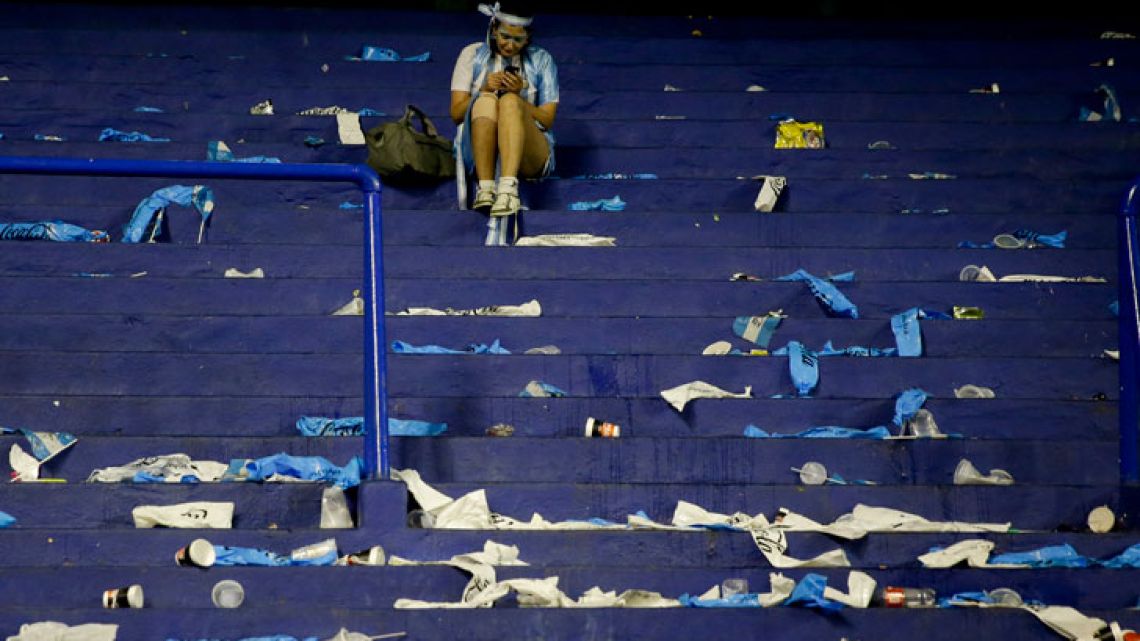 A dejected fan sits in the stands after Argentina's 0-0 draw with Peru last week.