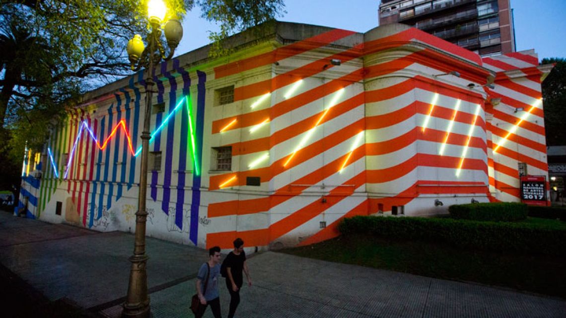 The usually impeccably white Palais de Glace, in bright-coloured stripes and wrapped in neon lights painted by French artist Bertrand Ivanoff as part of the recent opening of the South American biennale, Bienalsur in Buenos Aires, Argentina.