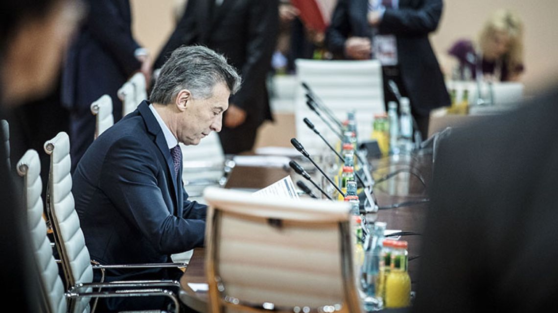 President Mauricio Macri checks papers before the before the start of the G20 summit’s third working session in Germany earlier this year.