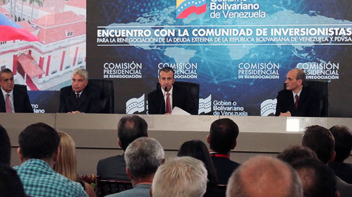 Venezuela’s Vice-President Tareck El Aissami (centre) speaks during a meeting with creditors and investors in Caracas on Monday.