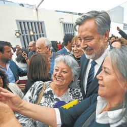 The New Majority coalition presidential candidate, Alejandro Guillier, poses for a photo with supporters at an event in Santiago.