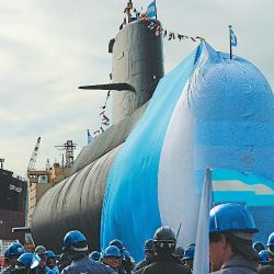 AFP/ EITAN ABRAMOVICH   AFP/ EITAN ABRAMOVICH  Workers stand around the ARA San Juan submarine during a ceremony celebrating the first stage of major repairs at the Argentine Industrial Naval Complex (CINAR) in Buenos Aires in November 2011.