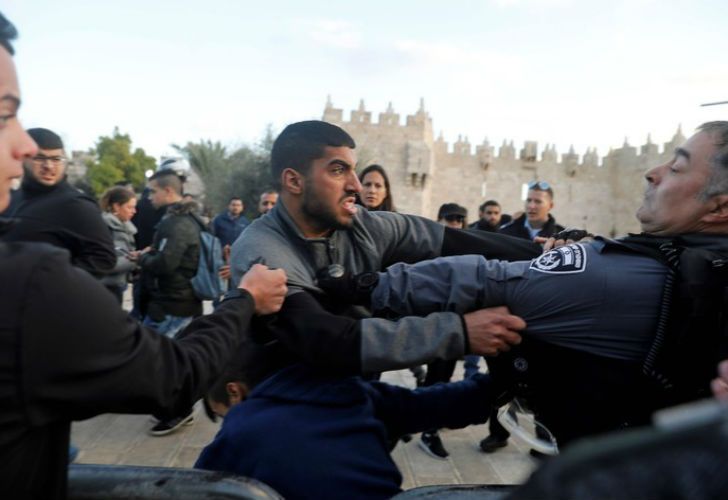 Efectivos policiales israelíes pelean con un manifestante palestino en las Puertas de Damasco, en la Ciudad Vieja de Jerusalén. 