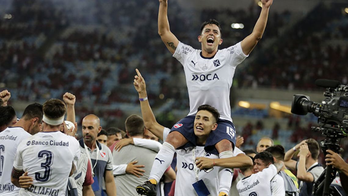 Independiente player Diego Rodríguez, top, celebrates with his teammates after they clenched the Copa Sudamericana championship title, after a 1-1 draw with Flamengo at Maracanã stadium in Rio de Janeiro last night.