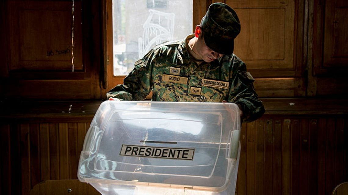 A Chilean soldier checks a ballot box at a polling station, at the Amunategui highschool in Santiago on December 15, 2017 during preparations ahead of the upcoming December 17, presidential election. 