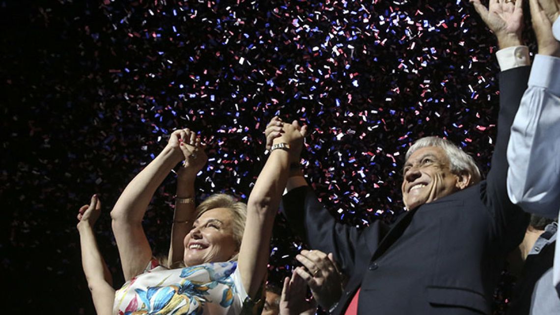 Former president Sebastián Piñera, with his wife Cecilia Morel, stands before supporters as he celebrates winning the presidential election run-off in Santiago on Sunday night.
