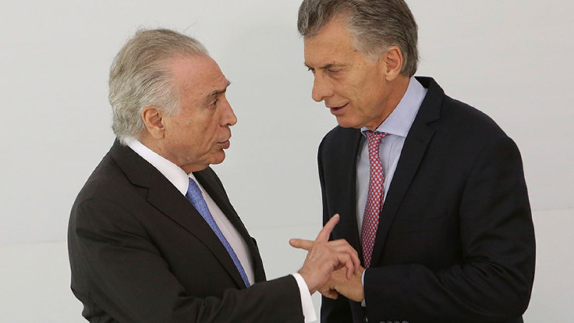Brazil's President Michel Temer, left, talks with Argentine President Mauricio Macri, before the official photo of the 2017 Mercosur and Associated States Summit of Heads of State.