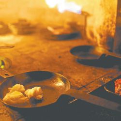 Calamari cooks inside a wood-burning oven at Proper restaurant in Palermo. 