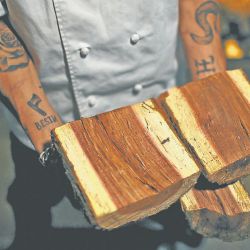 Bestia co-owner and chef Nacho Trotta shows the wood he uses to cook with at his restaurant.