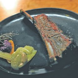 A barbecued rib sits on a plate at the Bestia restaurant that specialises in using fire and wood-burning ovens in Buenos Aires.