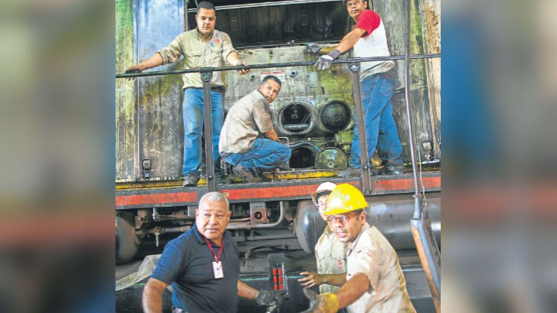 Workers repair a locomotive at Ferrominera Orinoco, in Ciudad Guayana, Bolívar state.