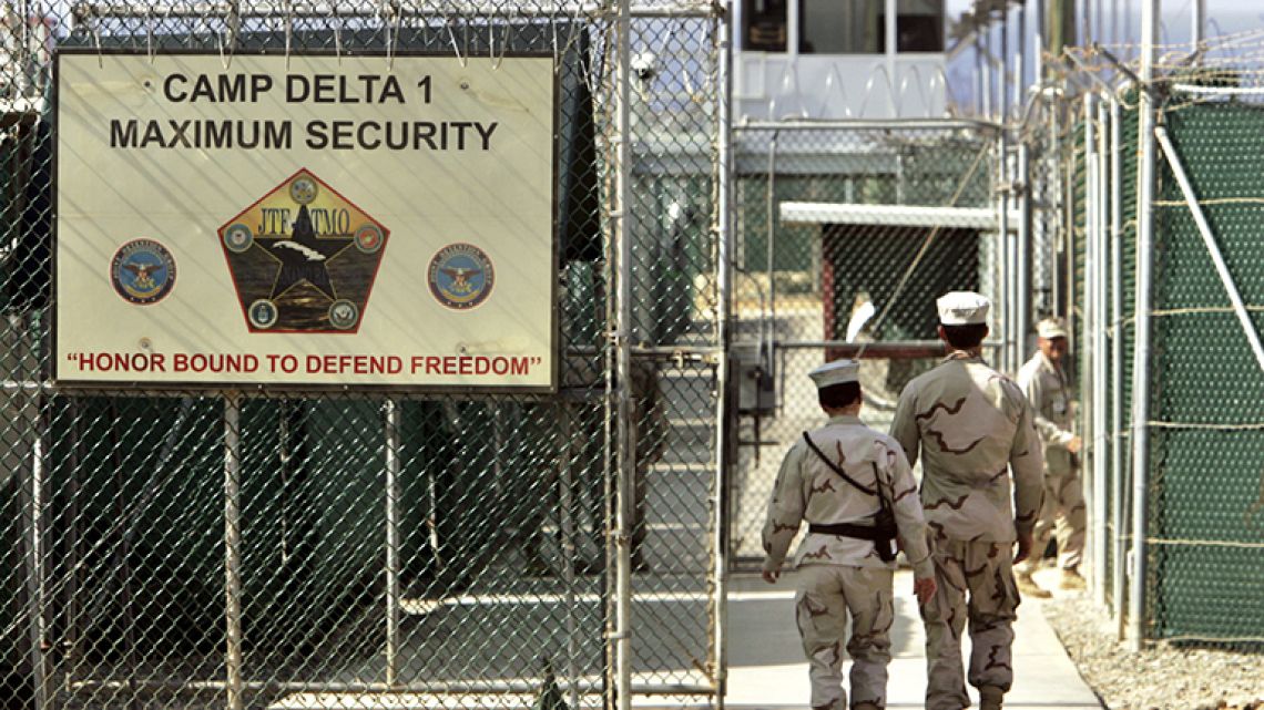 In this June 27, 2006 file photo, reviewed by a U.S. Department of Defense official, U.S. military guards walk within Camp Delta military-run prison, at the Guantanamo Bay US Naval Base, Cuba.