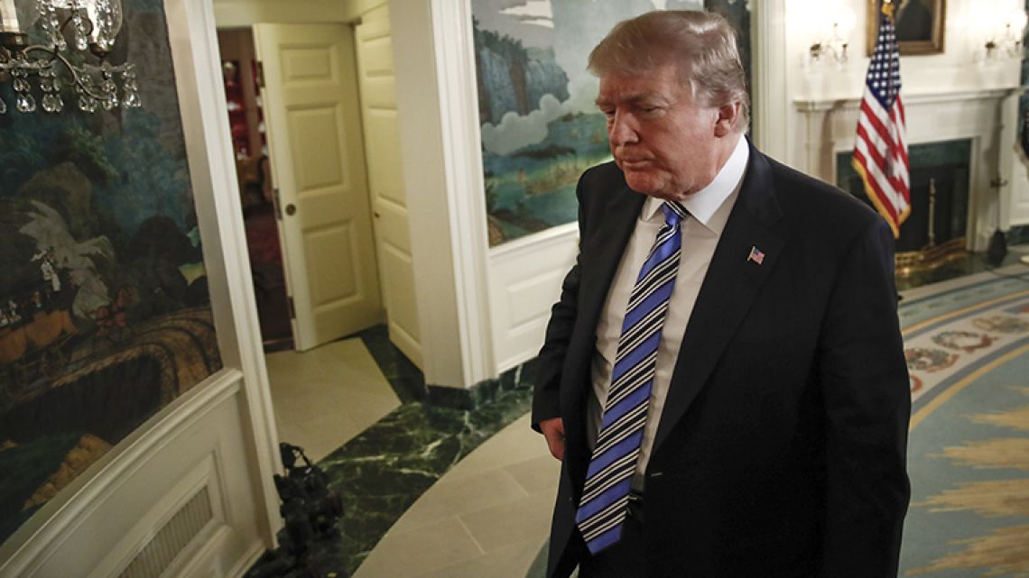 President Donald Trump walks from the Diplomatic Room of the White House, in Washington, Thursday, February 15, 2018, after speaking about the tragic school shooting in Parkland, Florida.