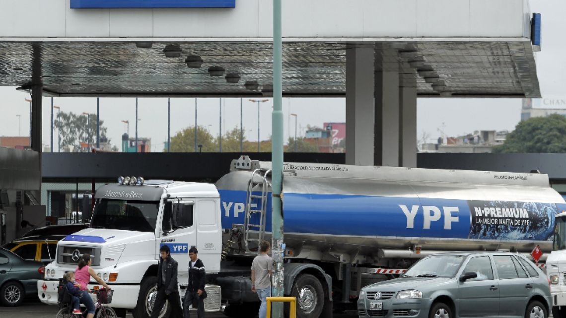 An YPF truck delivers fuel to a gas station.