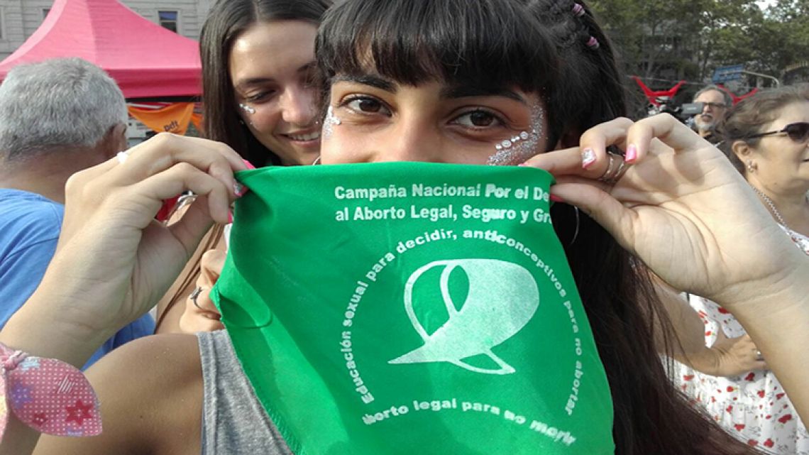 An activist shows off the bandana for the National Campaign for National Campaign for the Right to Legal, Safe, and Free Abortion at the National Congress.