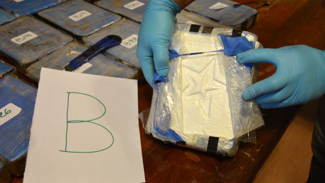 In this photo taken on December 14, 2016, released yesterday by the Security Ministry, a police officer shows a package of cocaine that with a star sign, that was found in an annex building of the Russian Embassy in Buenos Aires. A Russian diplomatic official and an Argentine police officer are among those arrested after authorities seized the cocaine shipment of 389 kilogrammes at the Embassy that prompted them to launch a yearlong joint investigation to dismantle a drug ring, the government said.