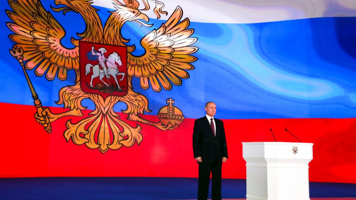 Russian President Vladimir Putin stands after giving his annual state-of-the-nation address in Manezh in Moscow.