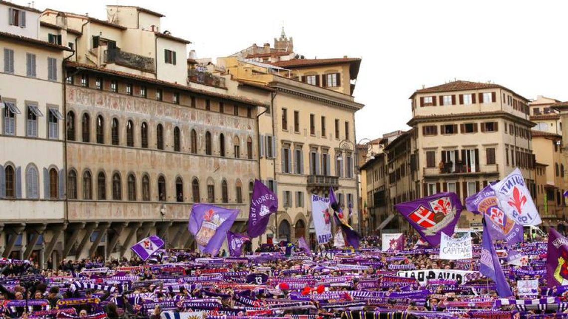 Fiorentina fans wait outside the church during Thursday’s funeral ceremony for Italian player Davide Astori in Florence, Italy.