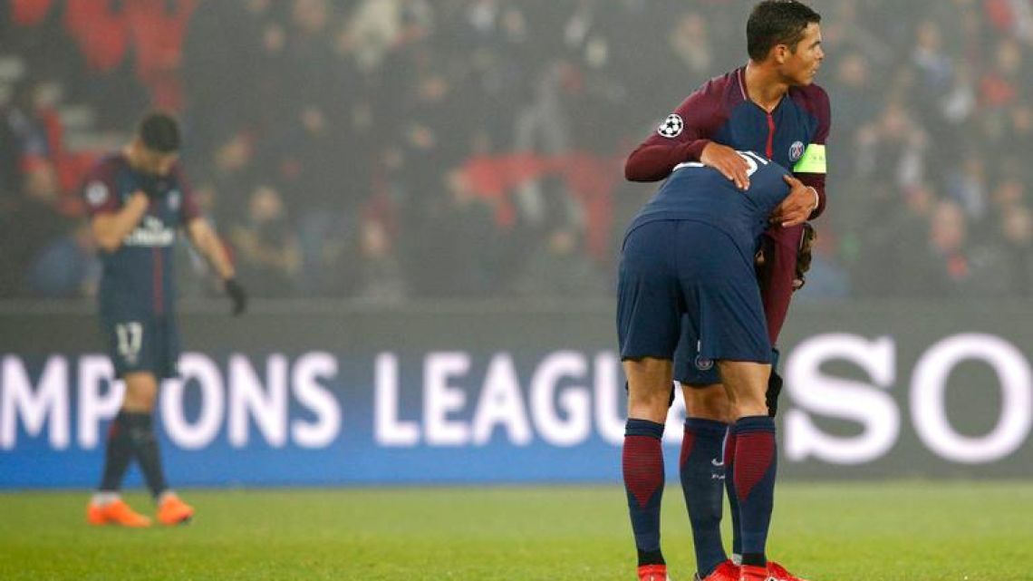 PSG captain Thiago Silva, right, hugs Adrien Rabiot after the Champions League Round of 16 second leg against Real Madrid in Paris on Tuesday.